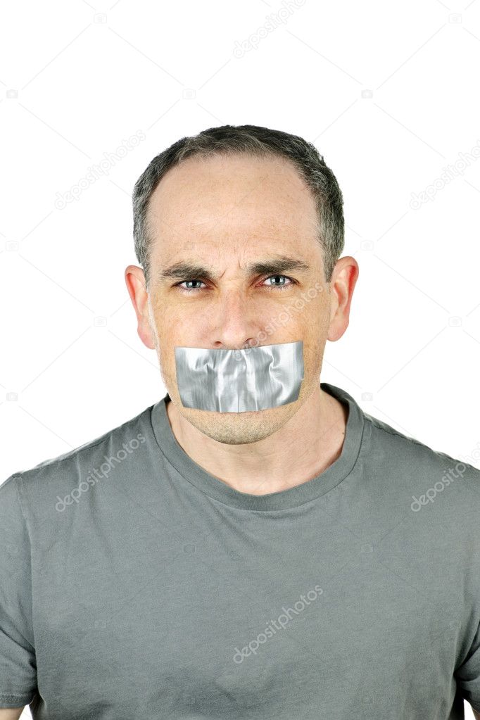 Portrait of angry man with duct tape over his mouth