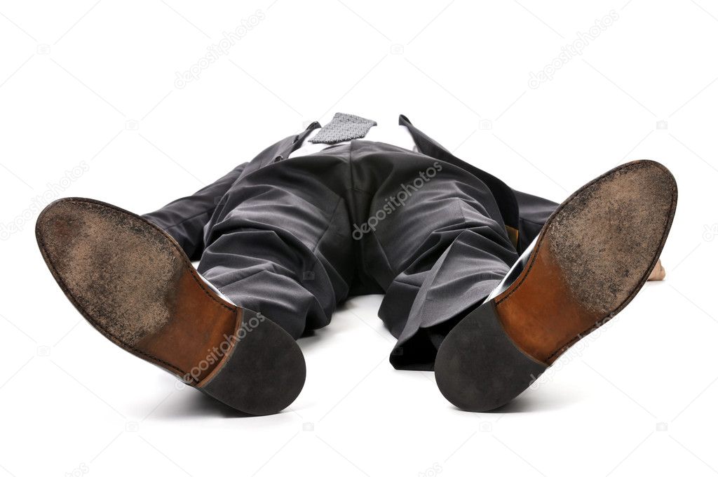 Businessman laying down in a suit isolated on white background