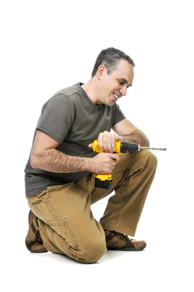 Kneeling Handyman Pushing His Cordless Drill — Stock Photo, Image