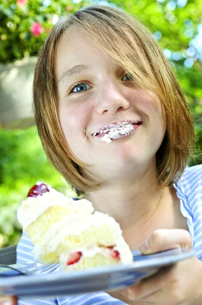 Girl eating a cake — Stock Photo, Image