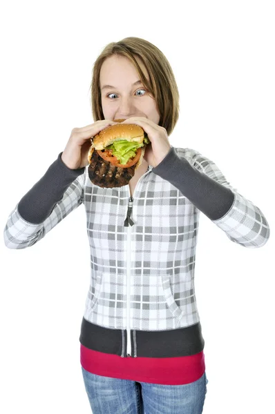 Teenage girl eating big hamburger — Stock Photo, Image