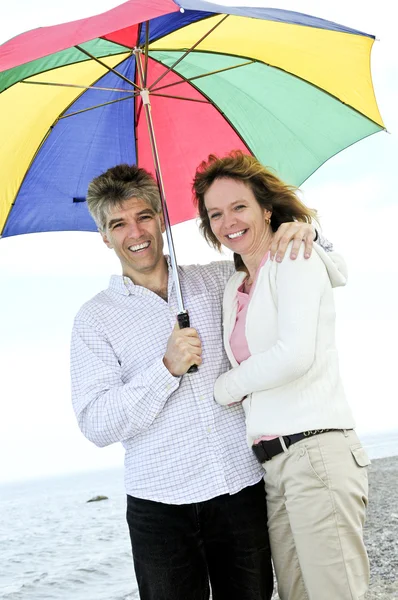 Happy mature couple with umbrella — Stock Photo, Image