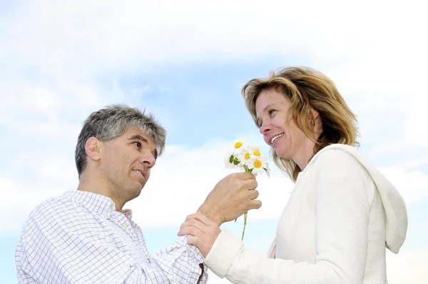 Ώριμο ρομαντικό ζευγάρι με λουλούδια — Φωτογραφία Αρχείου