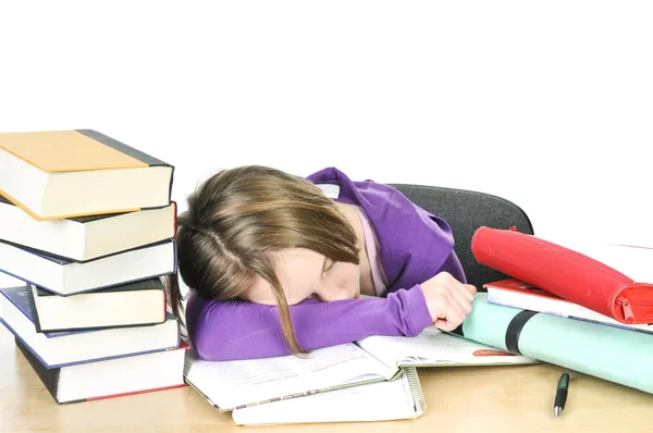 疲れている机で勉強して十代の少女 ストックフォト