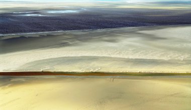 Aerial view of Atlantic ocean at low tide near Mont Saint Michel abbey in France. Background. clipart