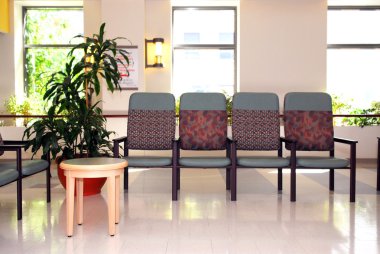 Waiting room in a hospital or clinic with empty chairs clipart