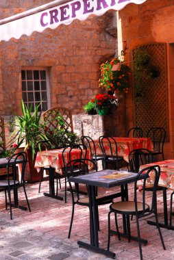 Restaurant patio in medieval town of Sarlat, France clipart