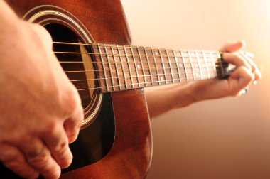 Person playing a guitar clipart