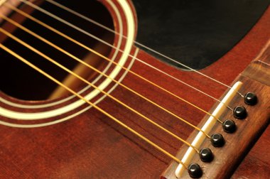 Acoustic guitar bridge and strings close up clipart