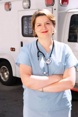 Female doctor or paramedic in front of an ambulance clipart