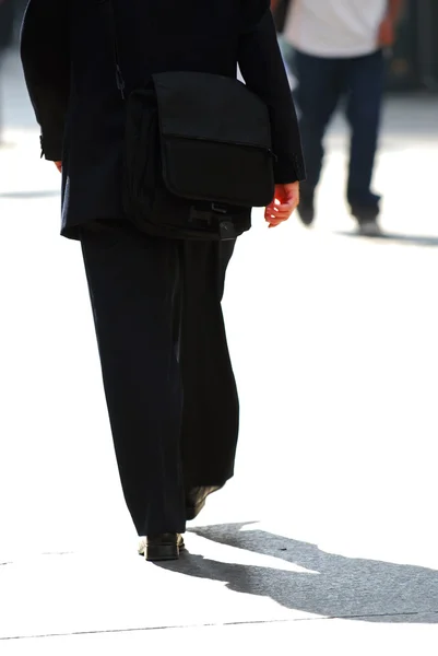 stock image Businessman walking on a busy street downtown