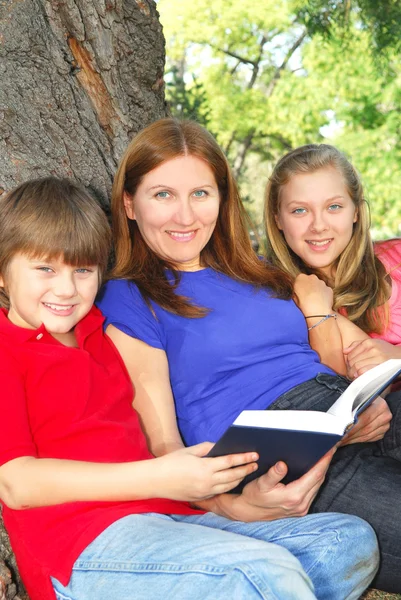 Сім Матері Дітей Читає Книгу Під Деревом Літньому Парку — стокове фото