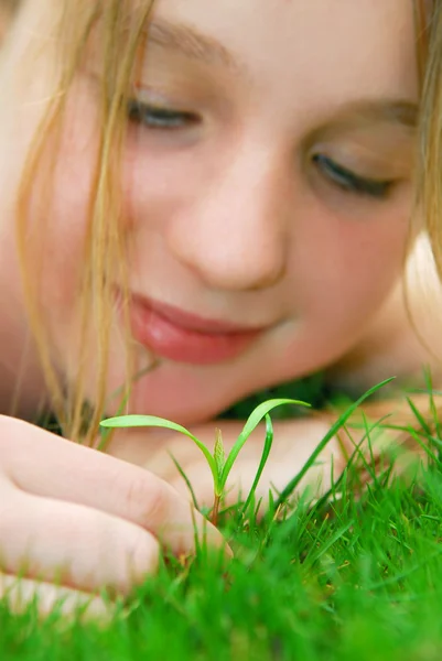 Girl and seedling — Stock Photo, Image