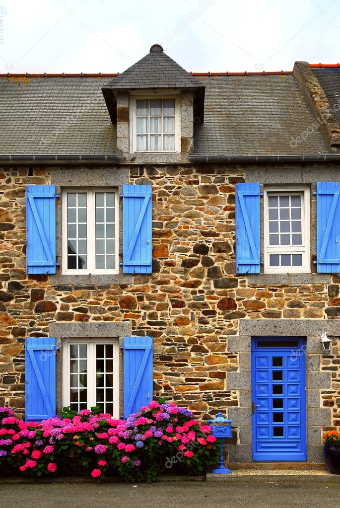 Typical country house with blue shutters in Brittany, France