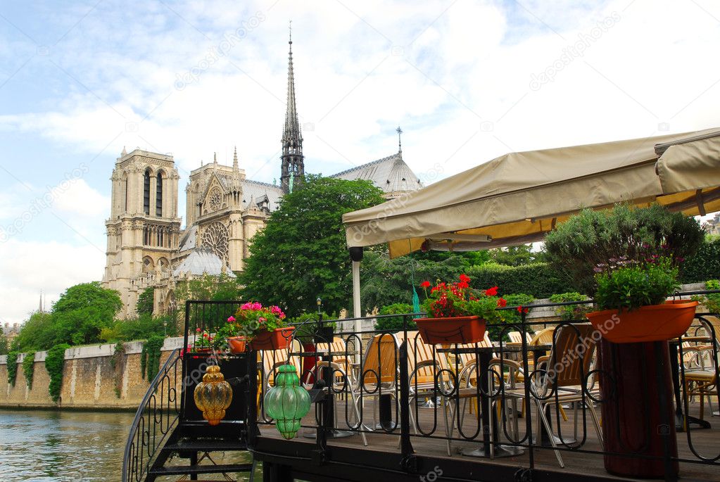 Restaurant on a boat on river Seine with the view of Notre Dame de Paris Cathedral in Paris France