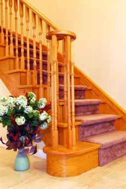 Interior of a house hallway with solid wood staircase clipart