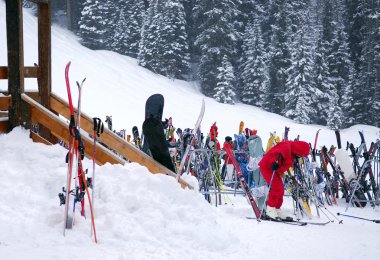 Ski rack near a chalet at downhill ski resort clipart