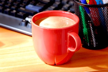 Coffee and keyboard on a desk clipart