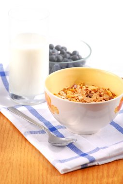 Healthy breaksfast of cereal, milk and blueberries clipart