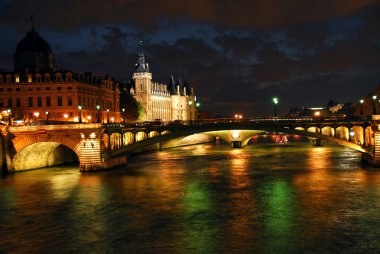 Bridges over Seine and Conciege in nighttime Paris France clipart