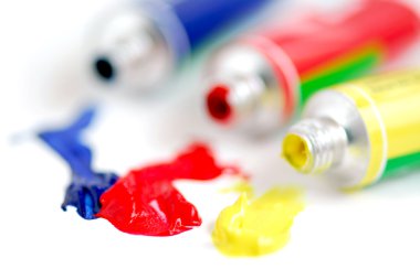 Macro of paint tubes of primary colors clipart