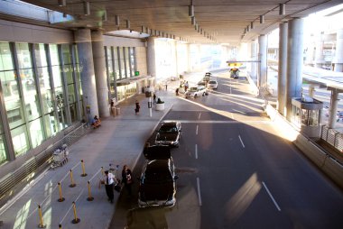 Travelers getting taxis at airport clipart