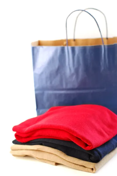 Folded Sweaters Paper Shopping Bag White Background — Stock Photo, Image