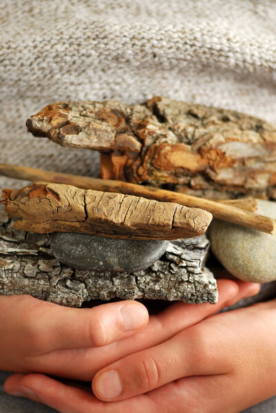 Child hands holding beach treasures collected on sea shore