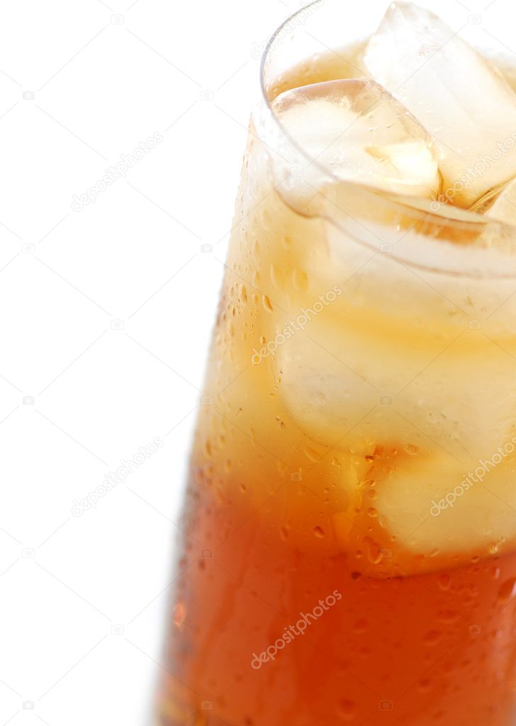 Glass of cold iced tea with water drops on surface