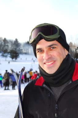 Portrait of a happy attractive man on downhill ski resort clipart