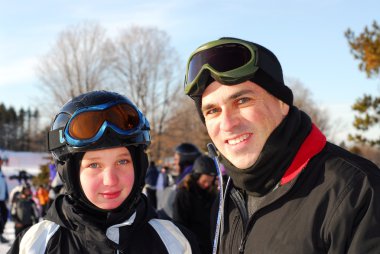 Portrait of a happy family on downhill ski resort clipart