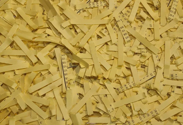 Yellow shredded paper as a background — Stock Photo, Image