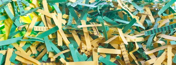 Green and yellow shredded paper — Stock Photo, Image
