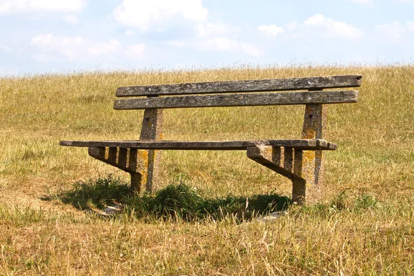 stock image Wooden bench on hillside