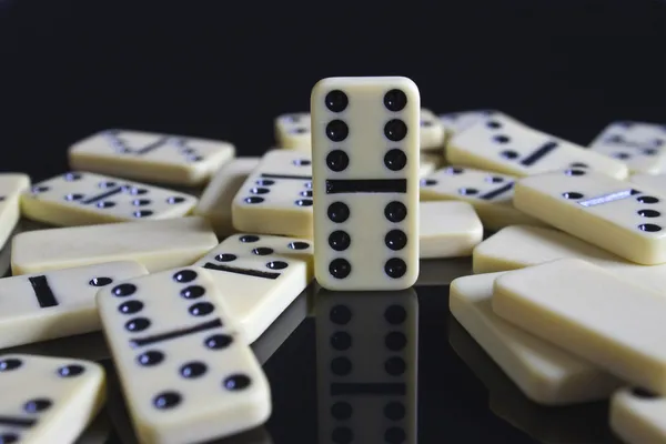 Dominos fallen around a double six — Stock Photo, Image