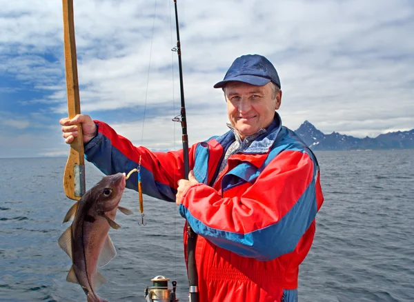 Fisherman with a fish on Lofoten island — Stock Photo, Image