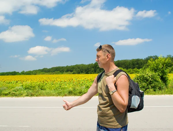 stock image Man stops the car on a road roadside