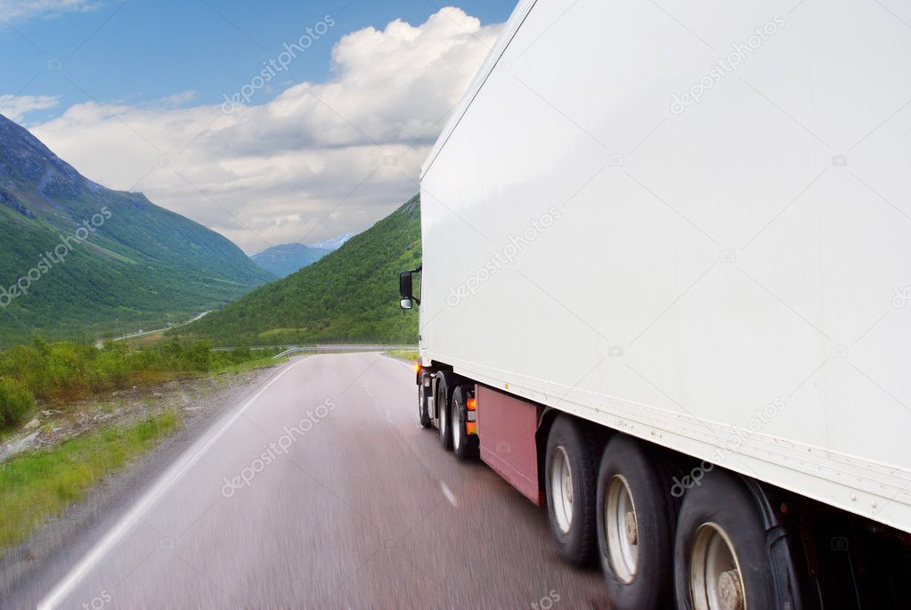 The white truck going on mountain road