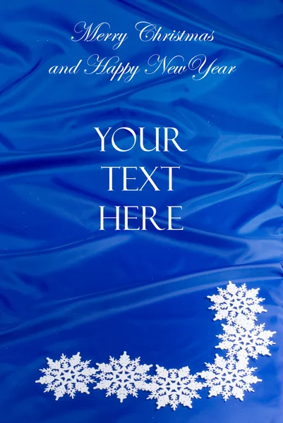 Buon Natale cartellino blu con fiocchi di neve Immagine Stock