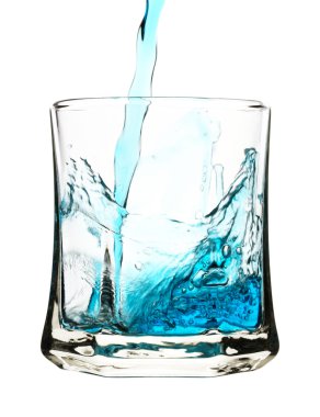 Blue drink is being poured into glass clipart