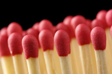 Red matchsticks on black background clipart