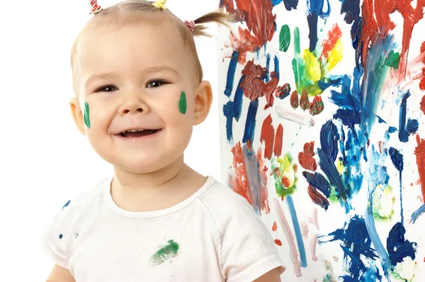 Happy little girl and her paintings — Stock Photo, Image