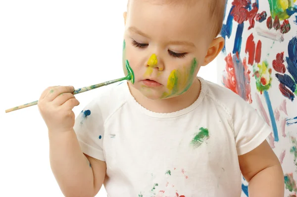 Маленькая девочка рисует на щеке — стоковое фото