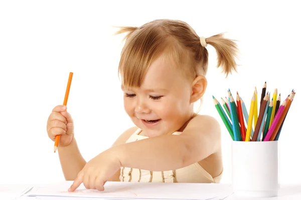 Barnet pekar på hennes teckning och leende — Stockfoto