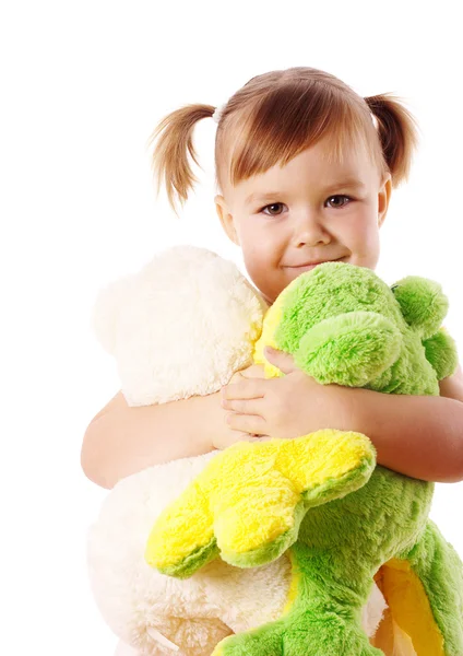Мила дівчина обіймає її м'які іграшки — стокове фото