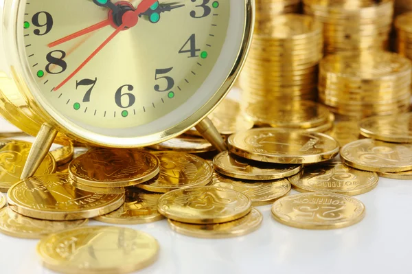 Часы циферблата и золотые монеты — стоковое фото