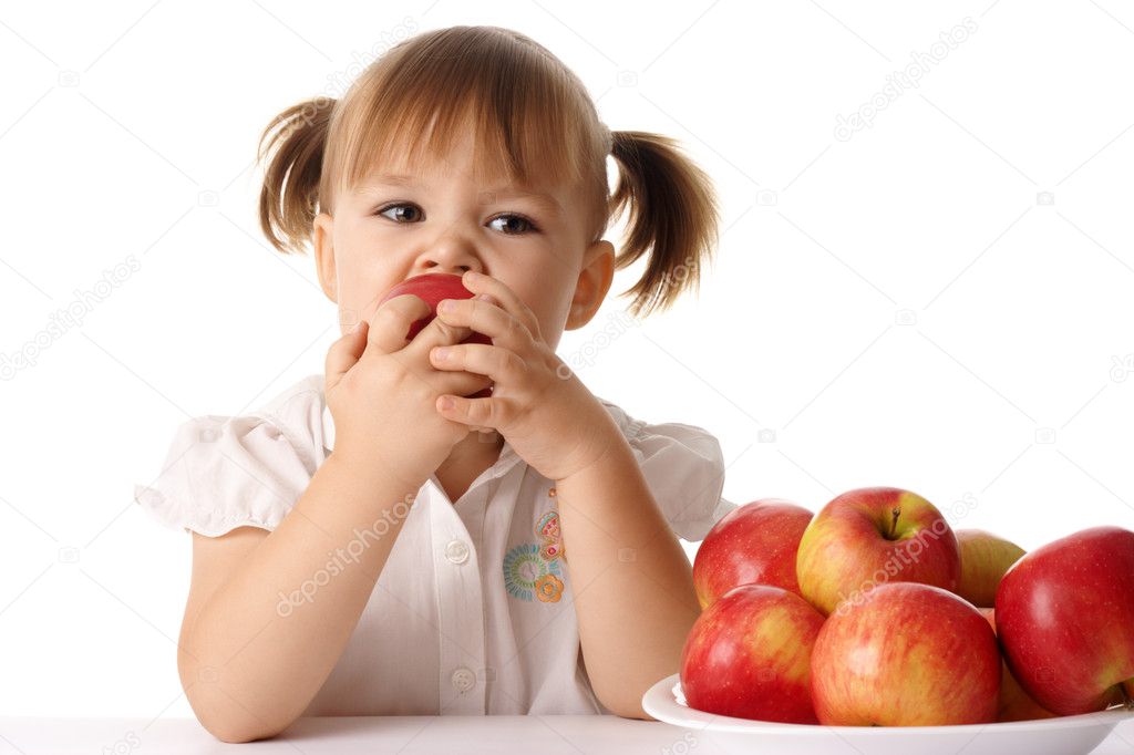 Child eats red apple