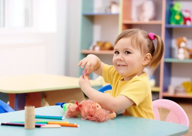 Little girl play in preschool clipart
