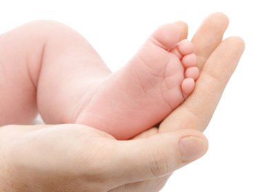 Mother holding her newborn's foot clipart