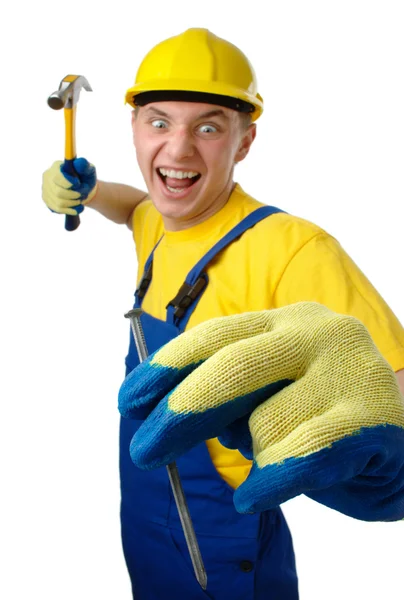 Young worker furiously hammering a nail — Stock Photo, Image